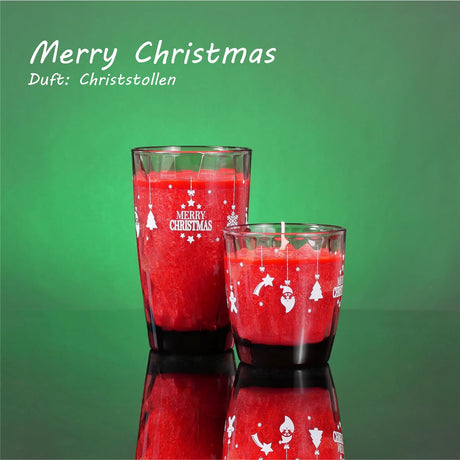 Zwei rote Merry Christmas Kerzen eine große eine kleine auf grünem Hintergrund 